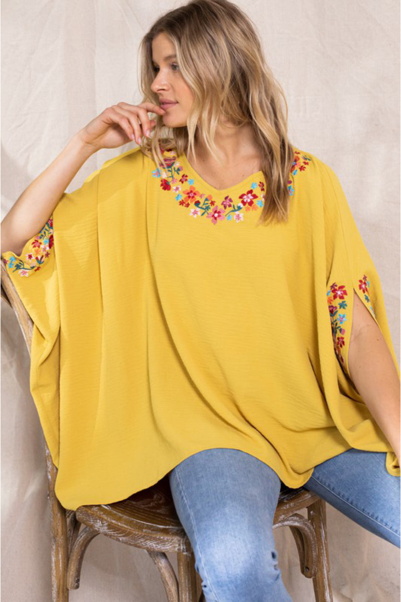 PONCHO WITH FLORAL DETAILS