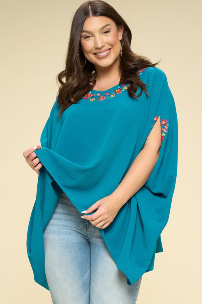 PLUS PONCHO WITH FLORAL DETAILS