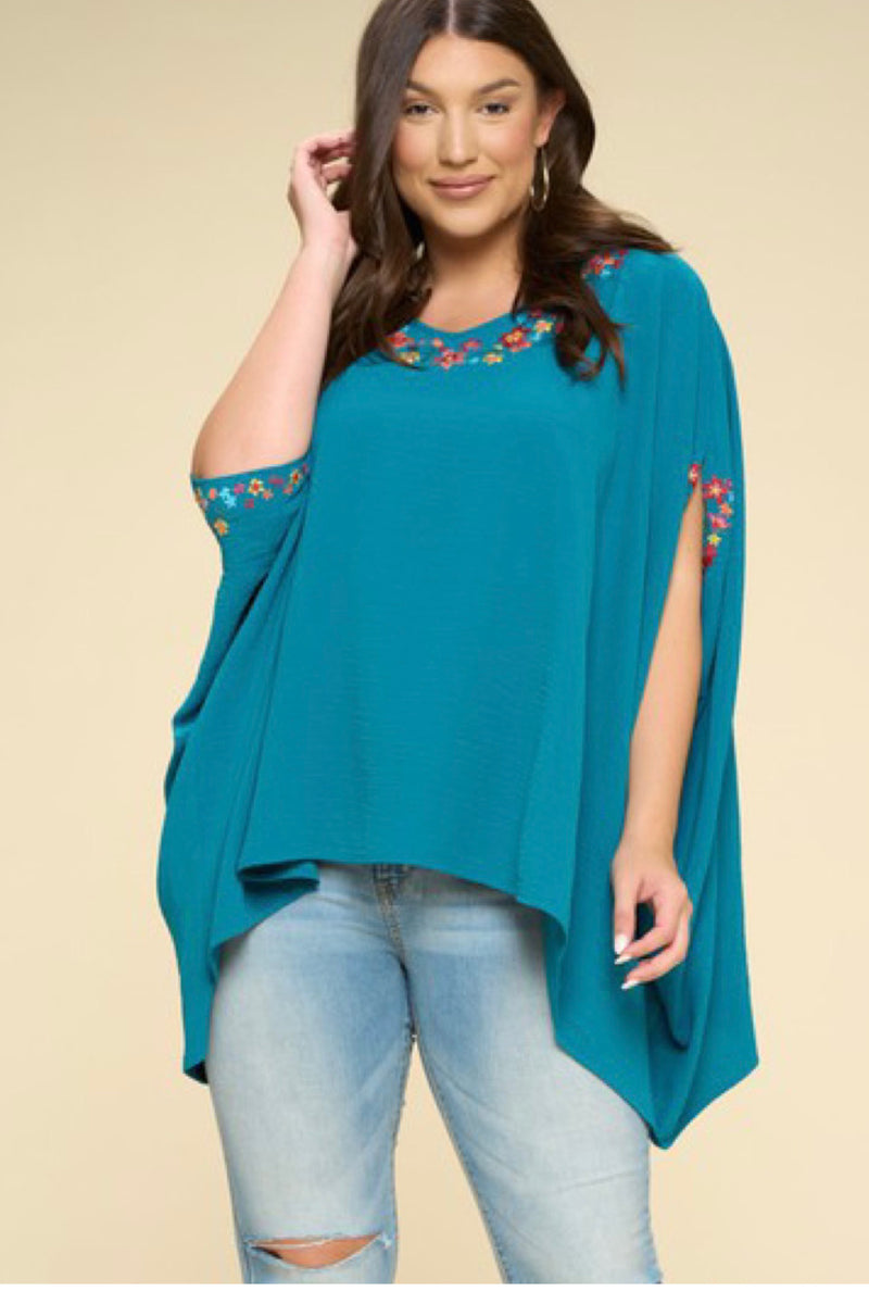 PONCHO WITH FLORAL DETAILS